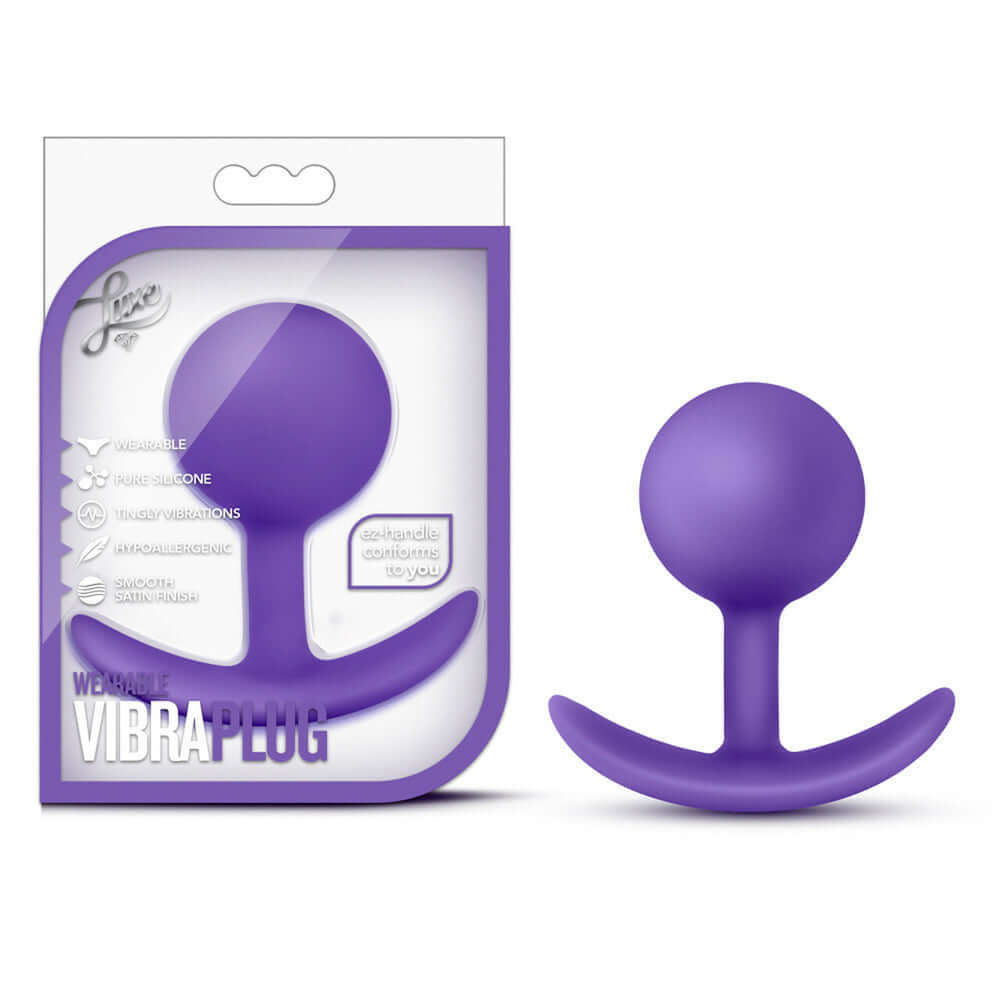 Luxe Wearable Vibra Butt Plug Purple displayed in packaging, featuring a smooth ergonomic design for pleasurable stimulation.