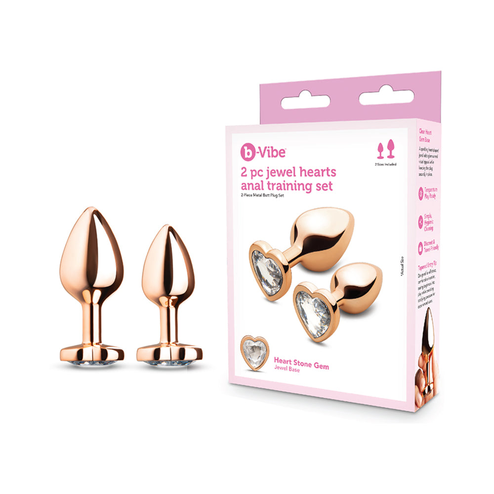 B-vibe Essentials 2-piece Jewel Hearts Anal Training Set featuring two gold anal plugs with heart-shaped jewel bases.