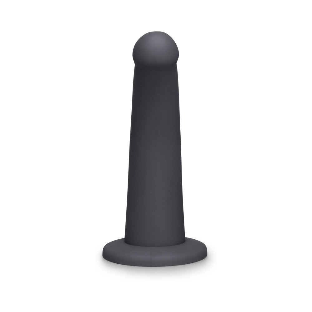 B-Vibe Essentials 7 Inch Smooth Silicone Dildo Black displayed on a white background, showcasing its sleek, modern design.