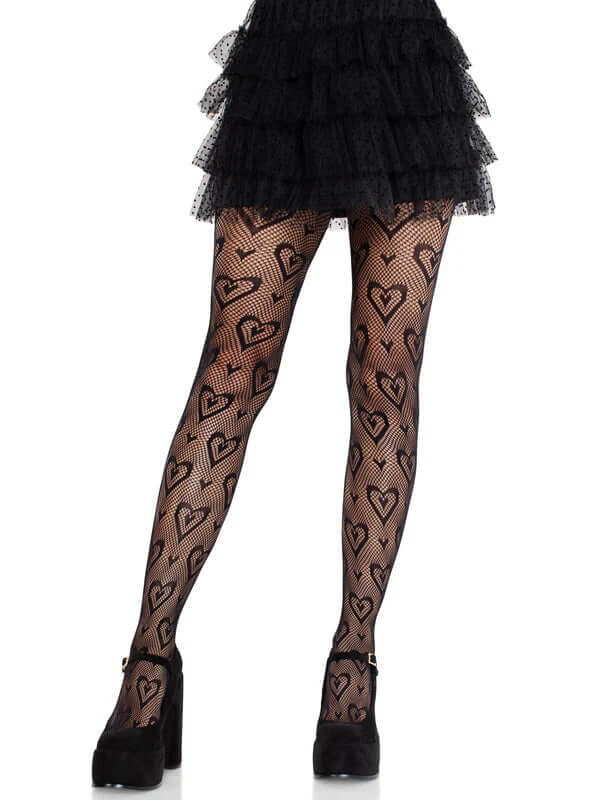 Leg Avenue Cherie Heart Net Tights Black OS featuring a playful heart pattern, styled with a black ruffled skirt and heels.