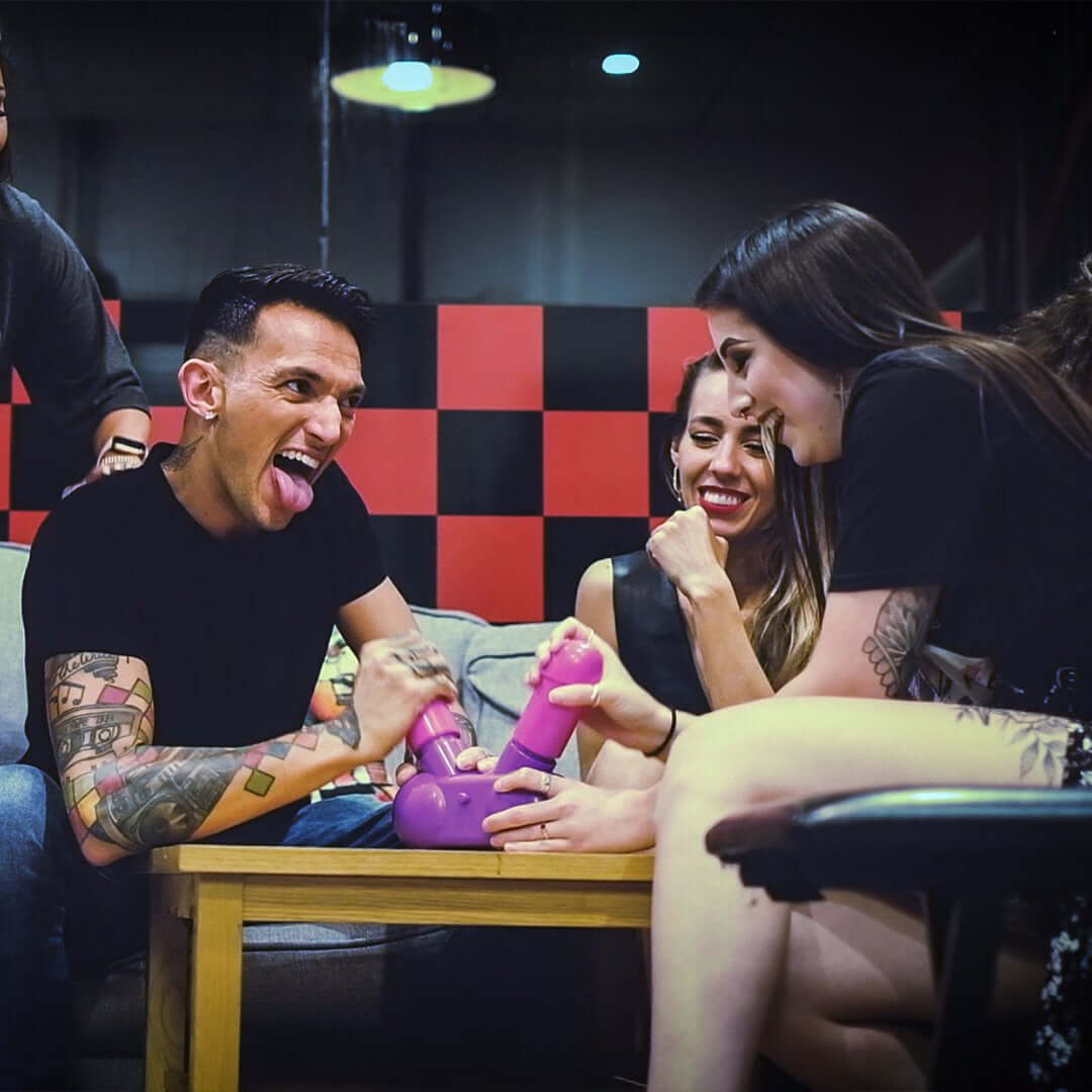 Participants enjoying the Cum Face Duel Pump Action Penis Game at a fun party, showcasing laughter and competition.