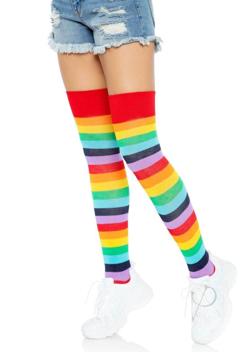 Leg Avenue Lycra Acrylic Rainbow Thigh High OS in colorful stripes worn with denim shorts and white sneakers.