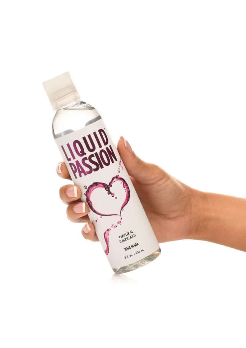 Liquid Passion Natural Water Based Lubricant 8 Oz in hand, showcasing its premium water-based formula.