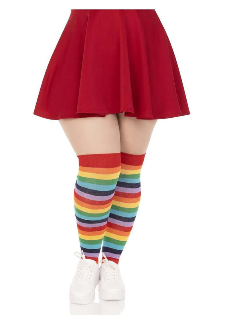 Leg Avenue Lycra Acrylic Rainbow Thigh High 1X 2X featuring bold rainbow stripes paired with a red skirt and white sneakers.