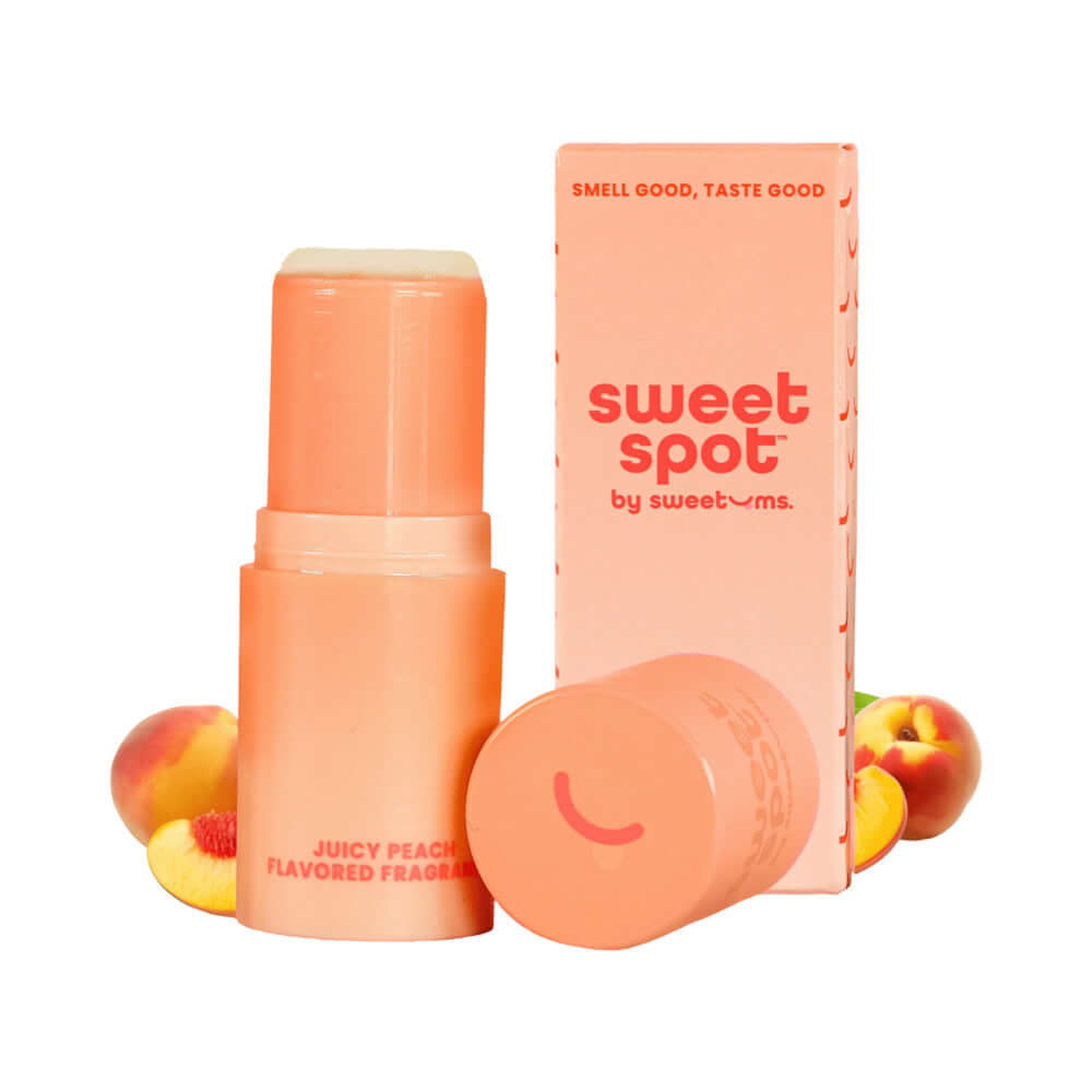 Sweetums Sweet Spot Flavored Fragrance Juicy Peach solid fragrance stick with peach background.