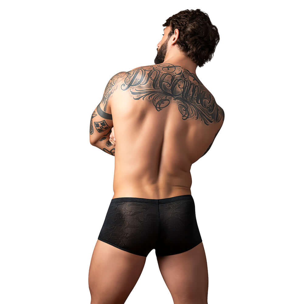 Male Power Kilauea Limited Edition Mini Short Black M model showcasing back view with tattoos.