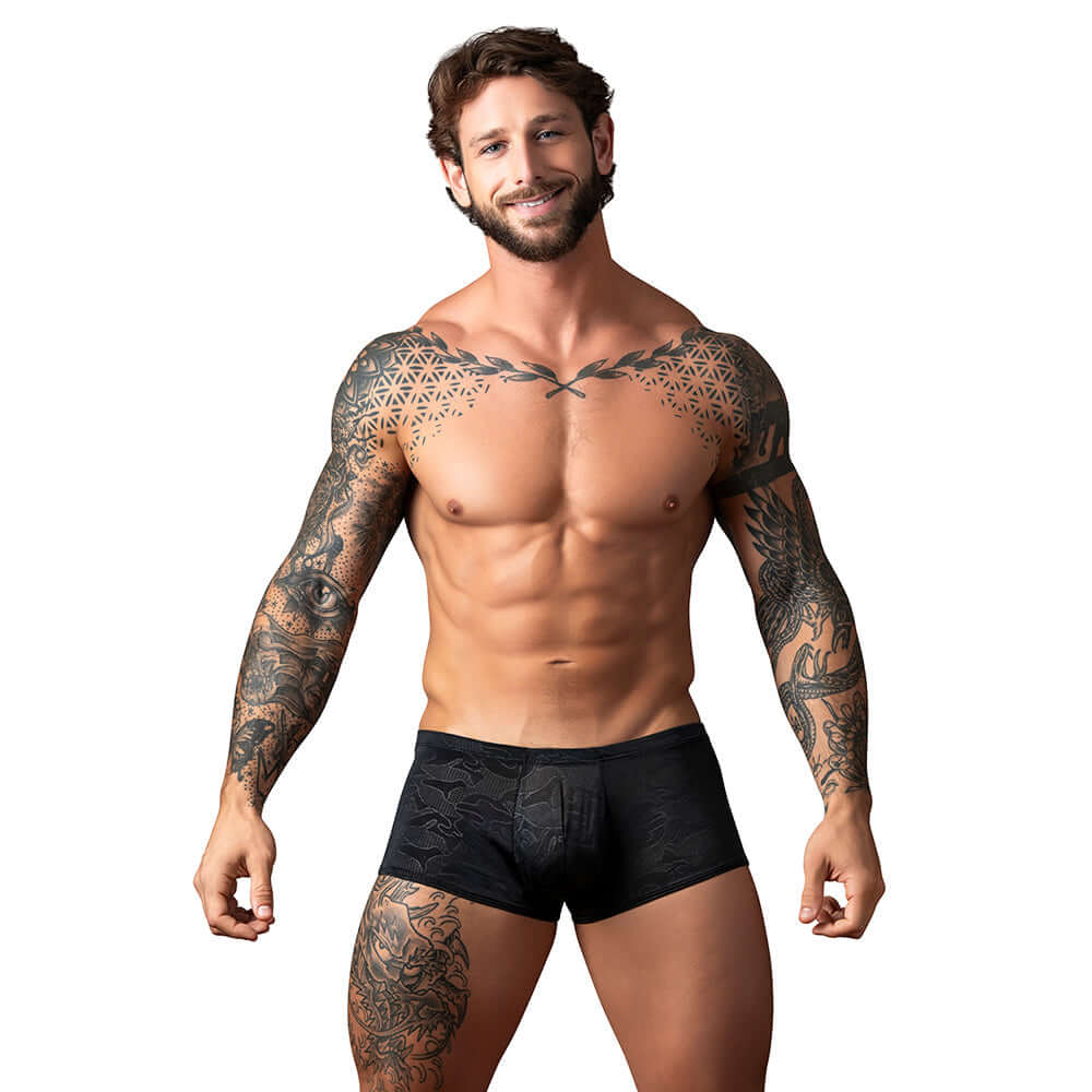 Male Power Kilauea Limited Edition Mini Short Black L model showcasing comfort and style with tattoos.