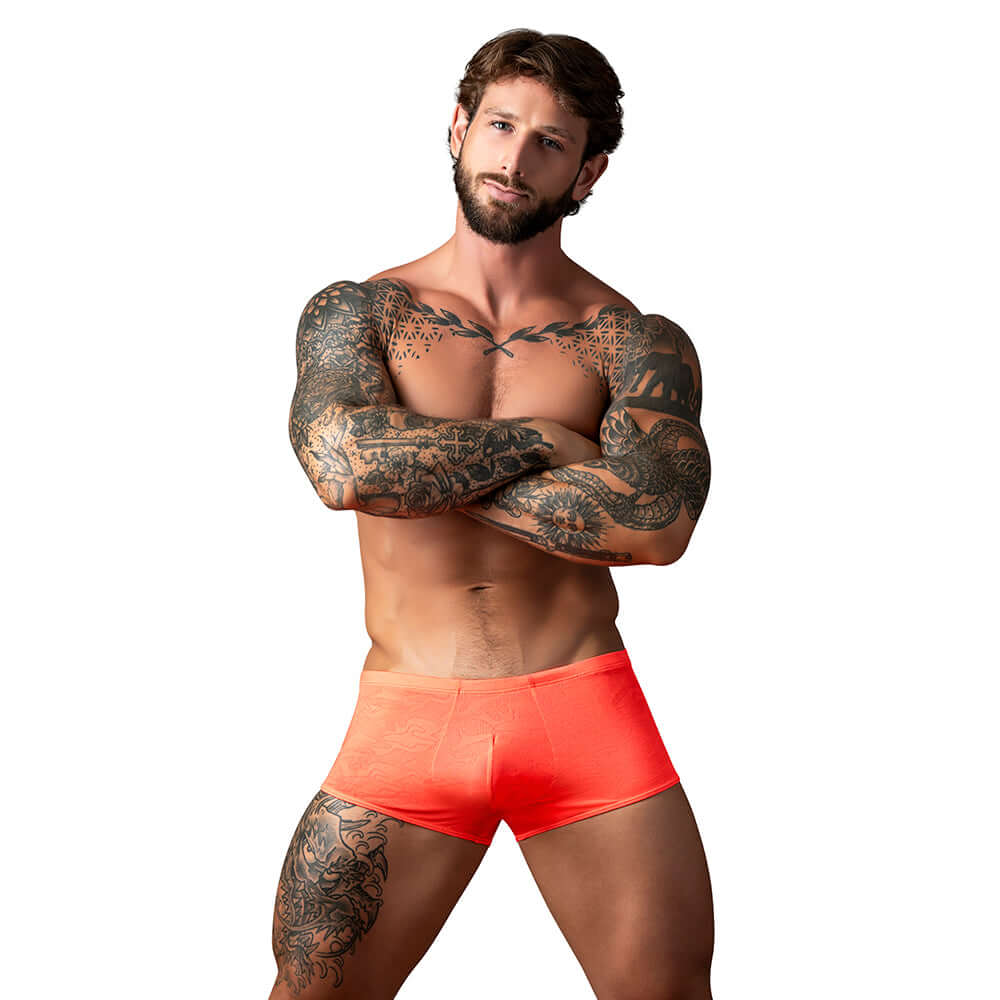 Male Power Kilauea Limited Edition Mini Short Coral L showcased on a muscular male model with tattoos.