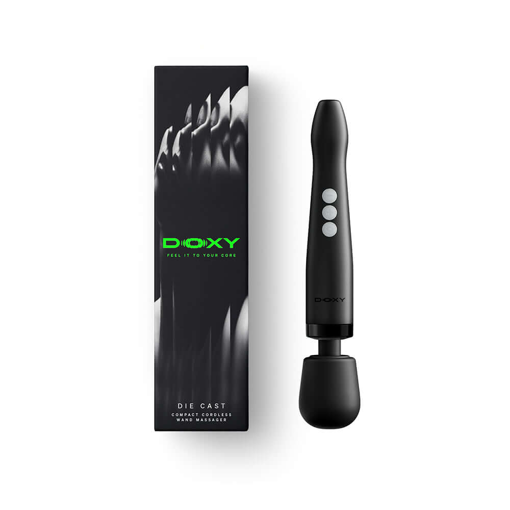 Doxy Die Cast Compact Cordless Wand Massager Black on display with packaging.