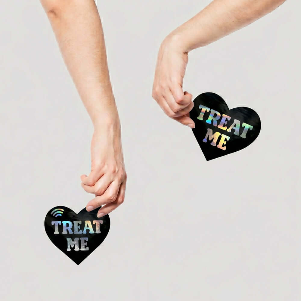 Neva Nude Treat Me Holographic Heart Smart Nfc Pasties in hands, showcasing stylish NFC technology for sharing.