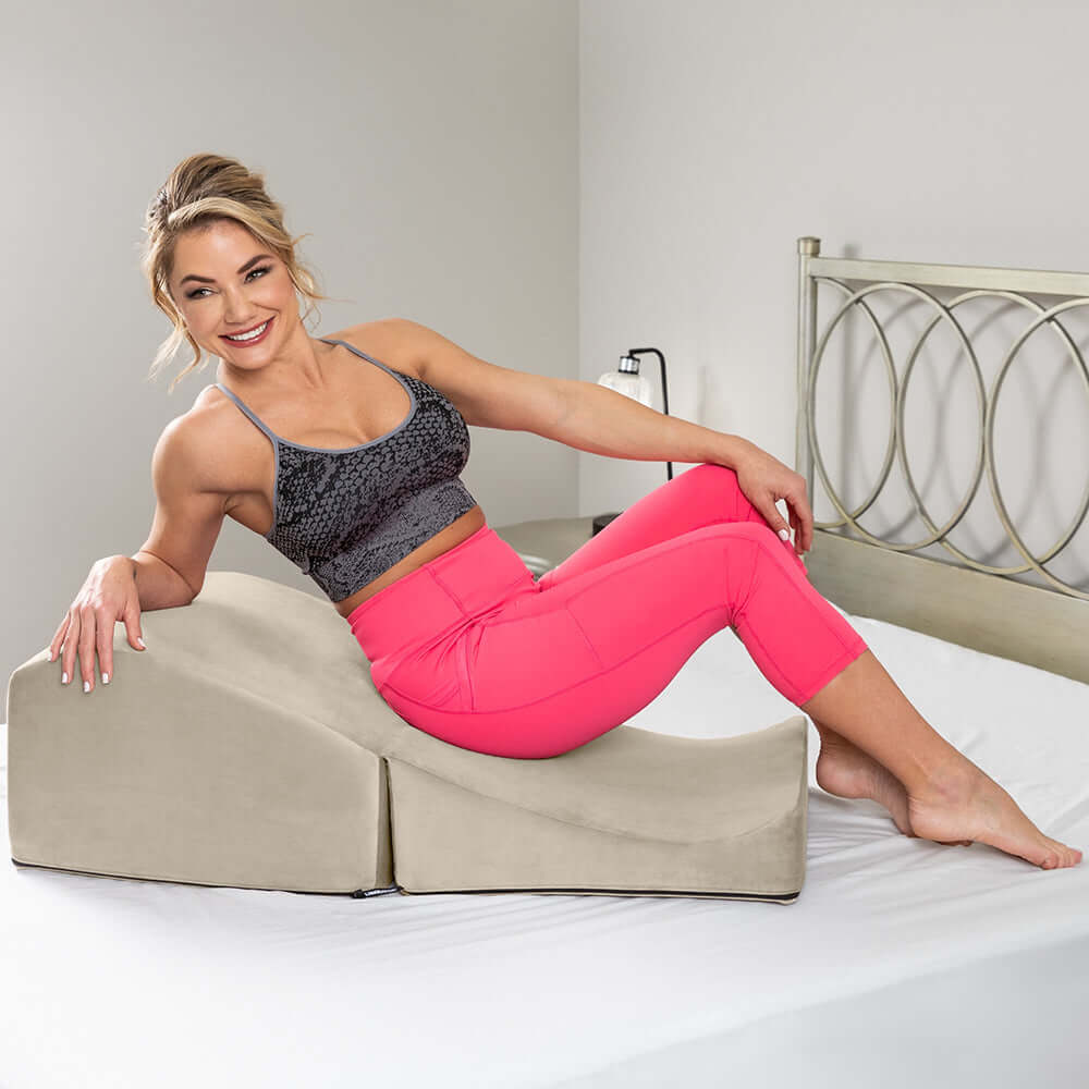 Liberator Flip Ramp Sex Positioning Pillow With Slip Cover Lush Cream in use with a woman lounging.