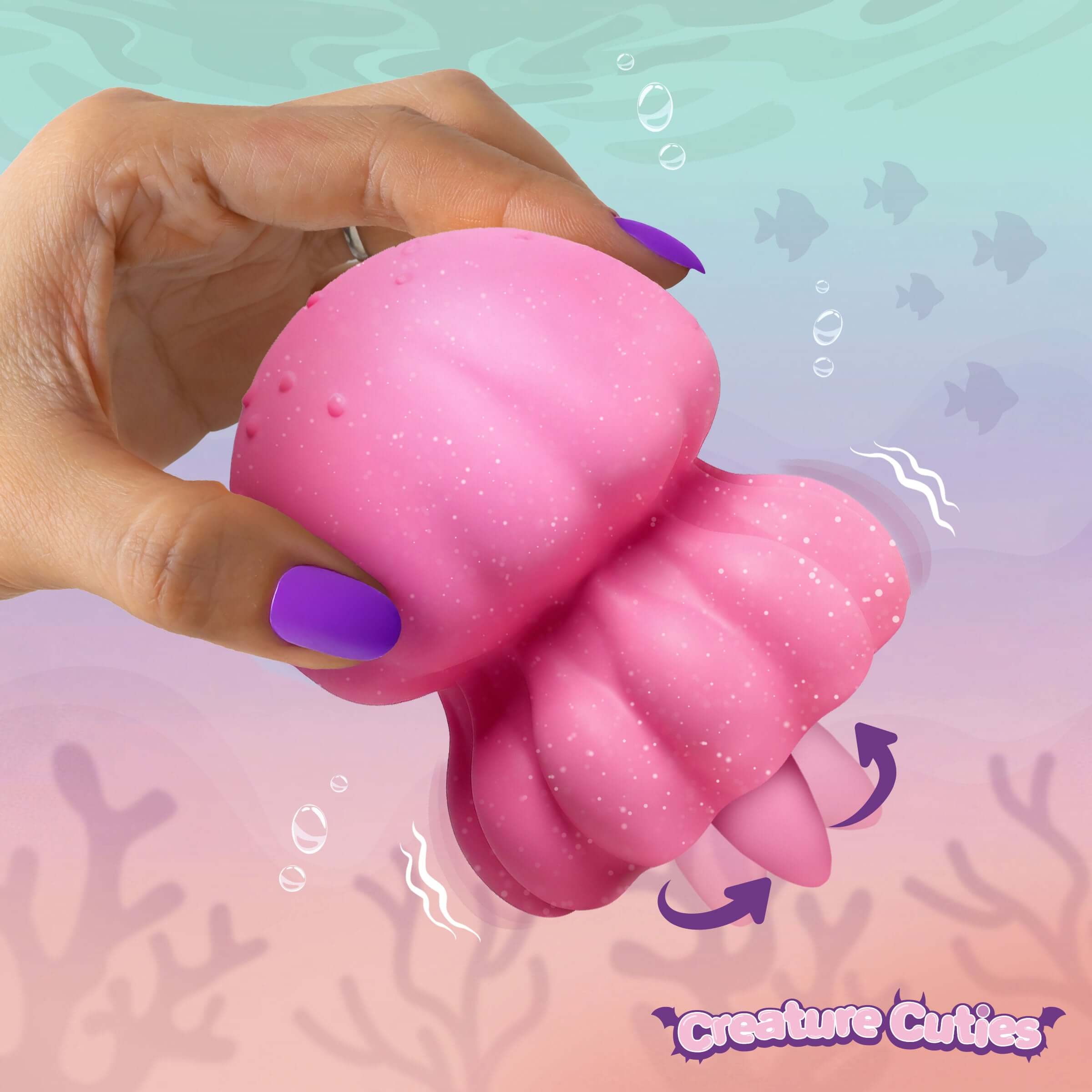Hand holding the Creature Cuties Glow Jelly Licking & Vibrating Stimulator, showcasing its jellyfish design.