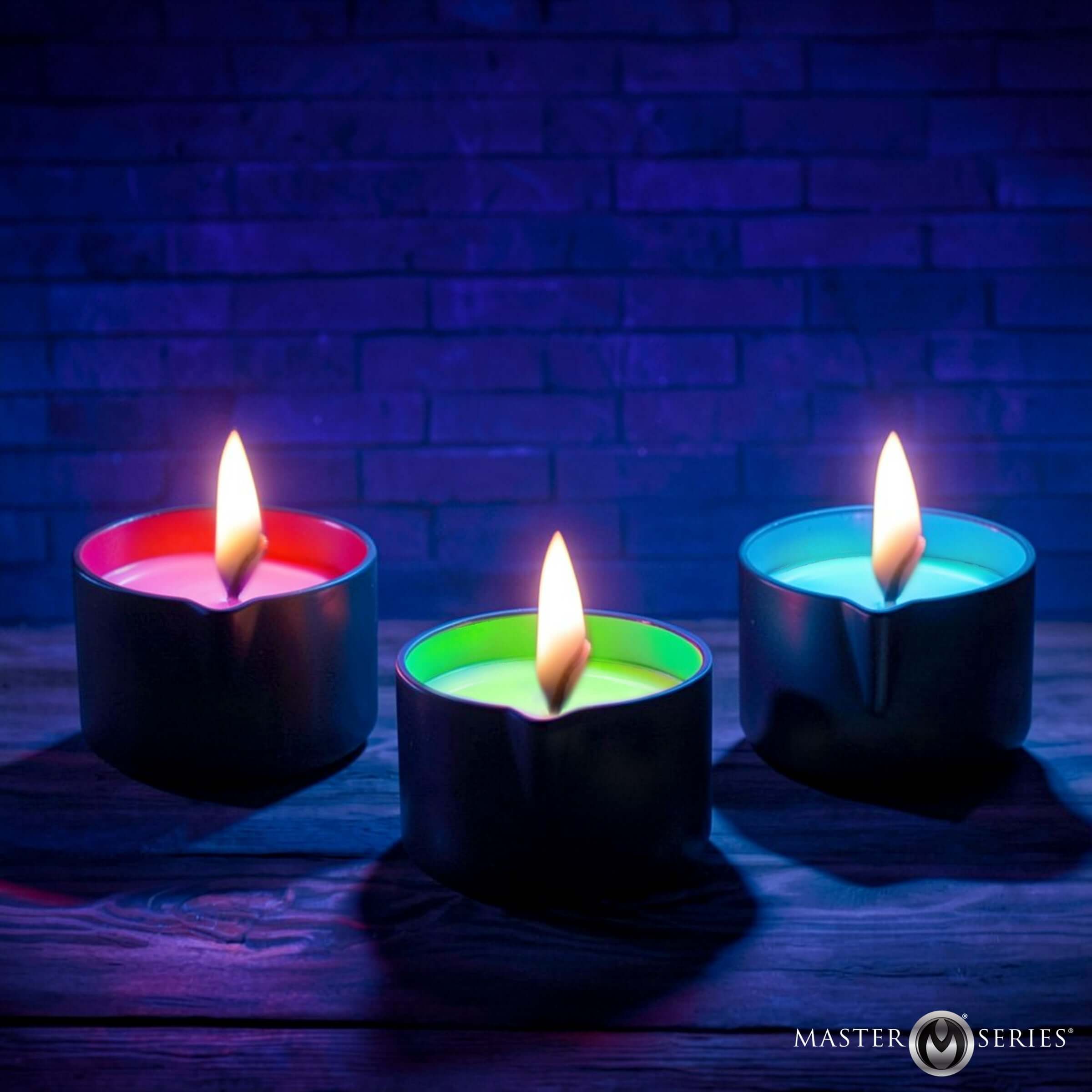 Wicked Wax Blacklight Reactive Drip Candle Set of 3 with vibrant red, green, and blue wax glowing under blacklight.