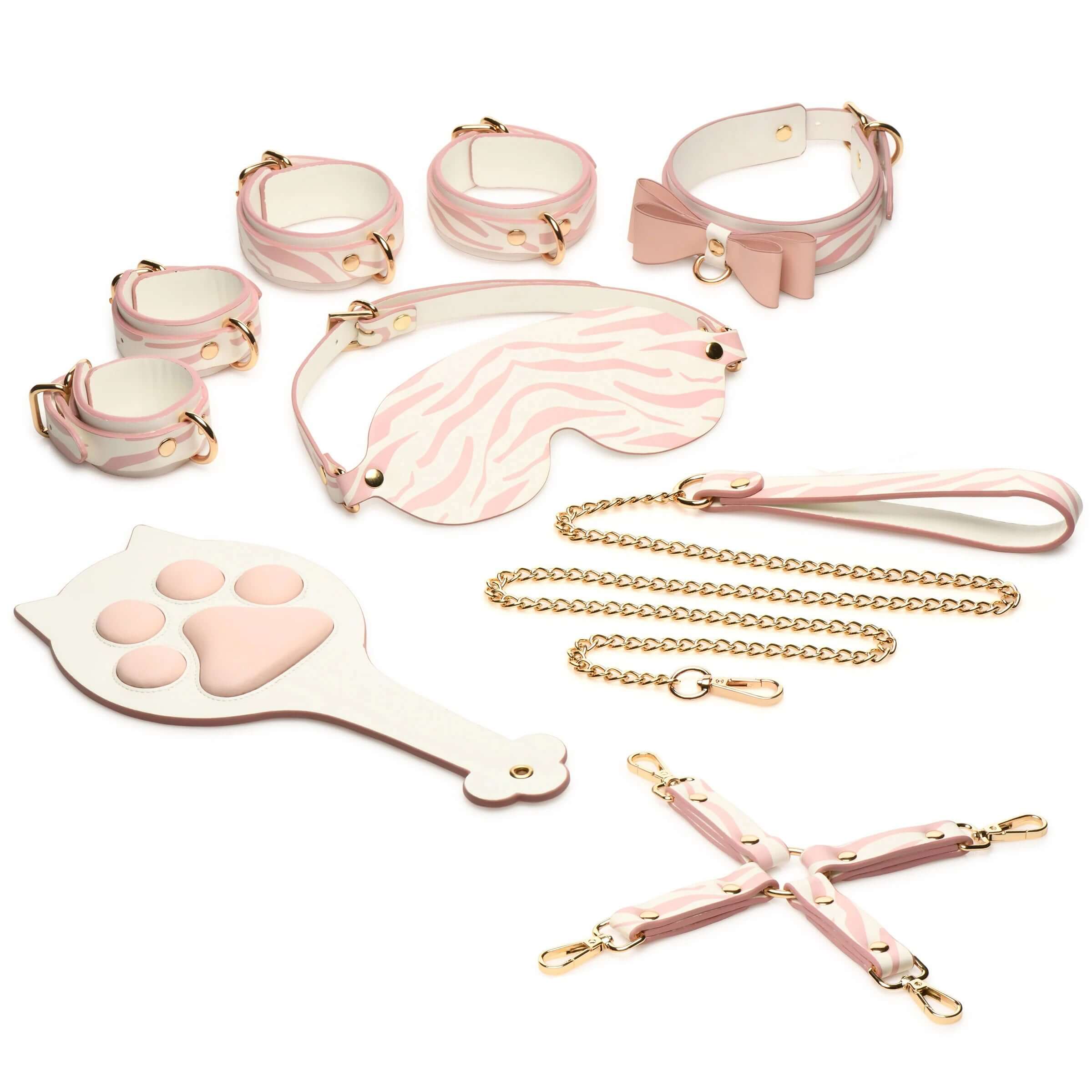 Pink Kitty Bondage Set in white and pink with vegan leather cuffs, blindfold, collar, leash, paddle, and hogtie arrangement.