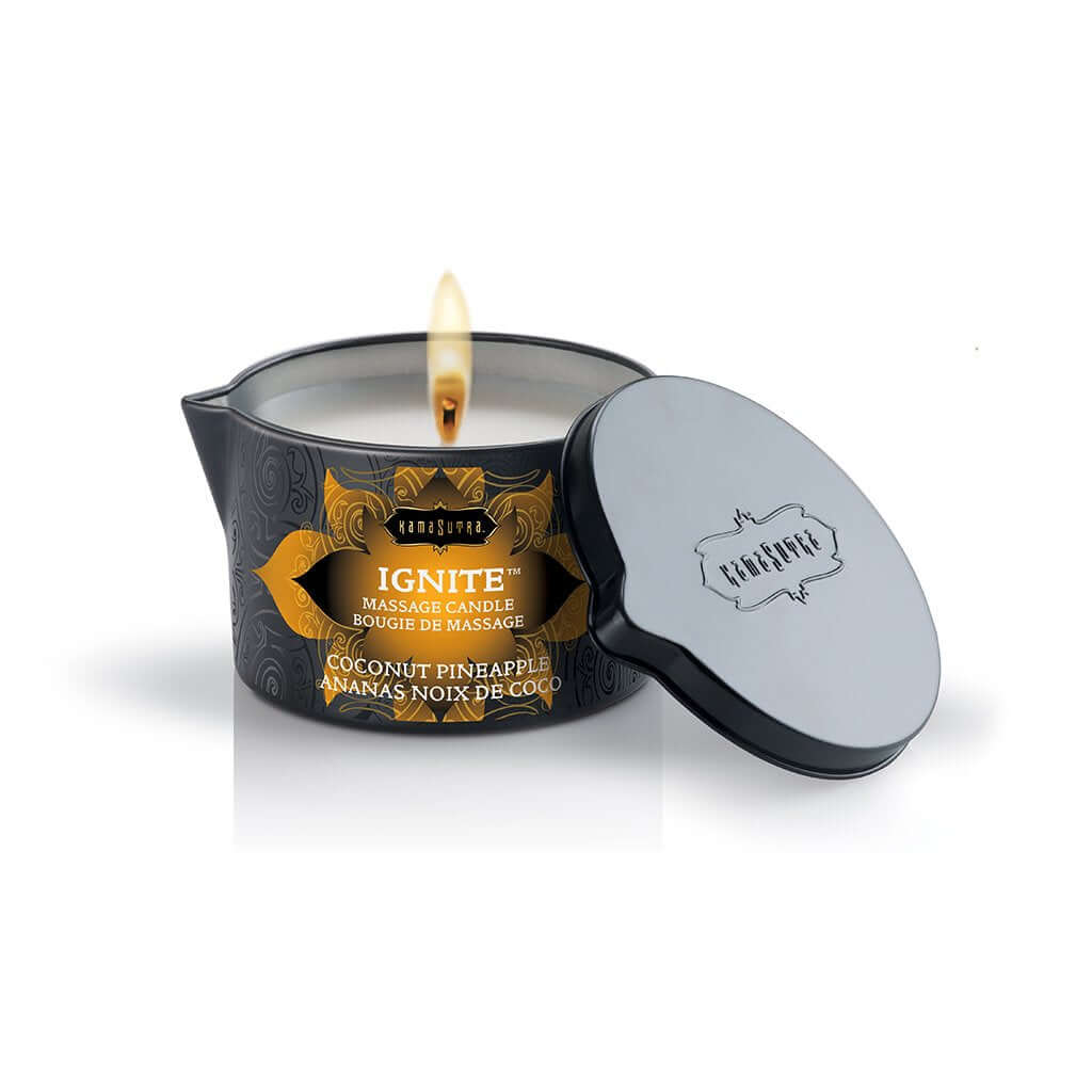 Kama Sutra Ignite Coconut Pineapple Massage Candle 6 Oz with a flickering flame and elegant packaging.
