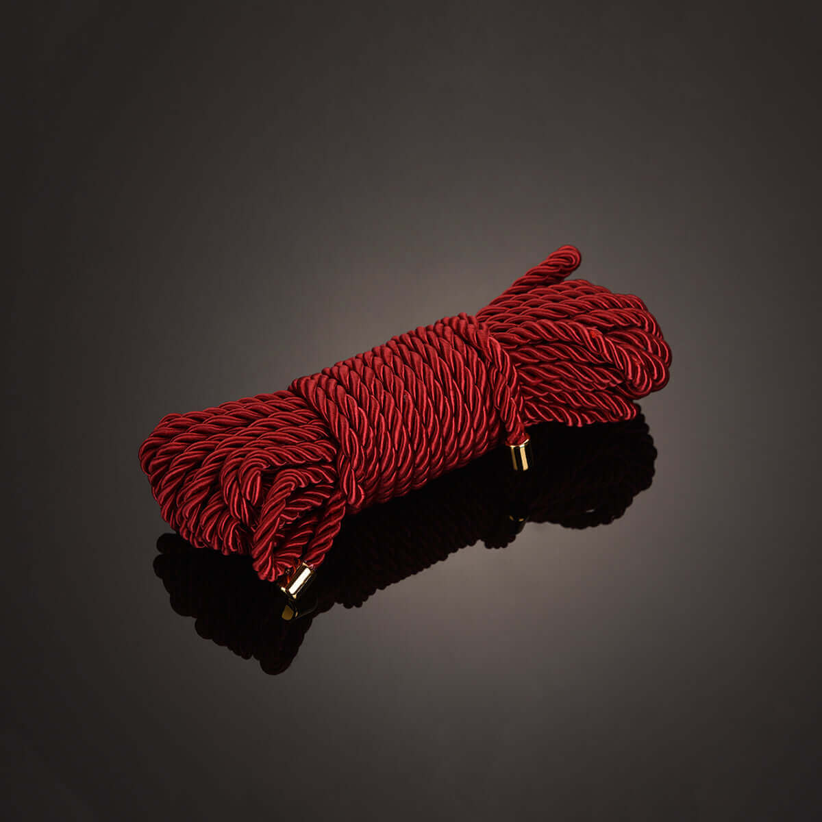 Luxurious red Shibari bondage rope, 32.8 ft long, ideal for workshops, featuring a glossy finish and sturdy ends.