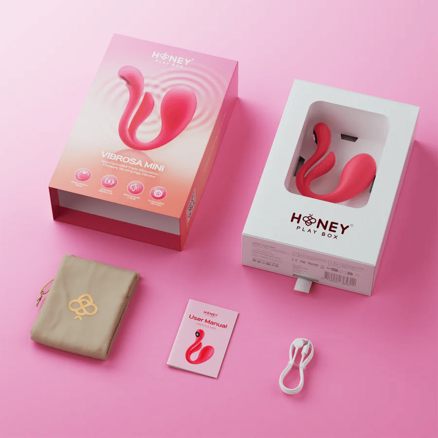 Package of Honey Play Box Mini Vibrosa Triple Stimulator Pink with accessories on pink background.