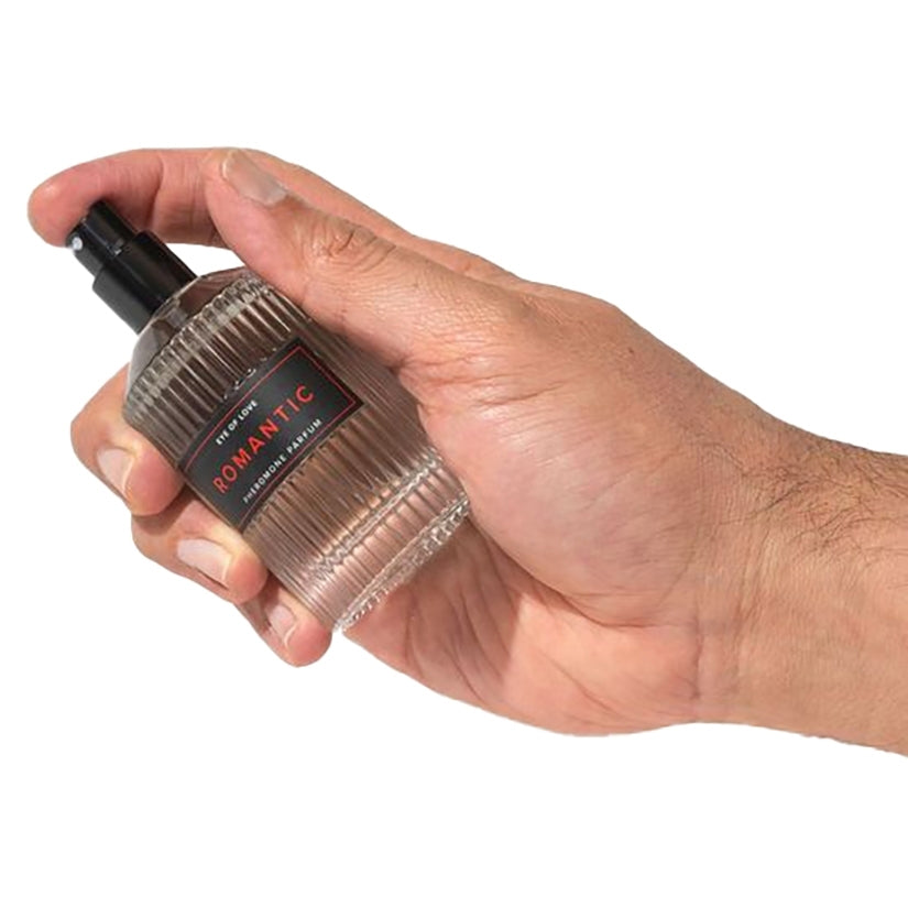Eye Of Love Romantic Pheromone Body Spray for Men 50ml held in hand ready for use, featuring a sleek design.