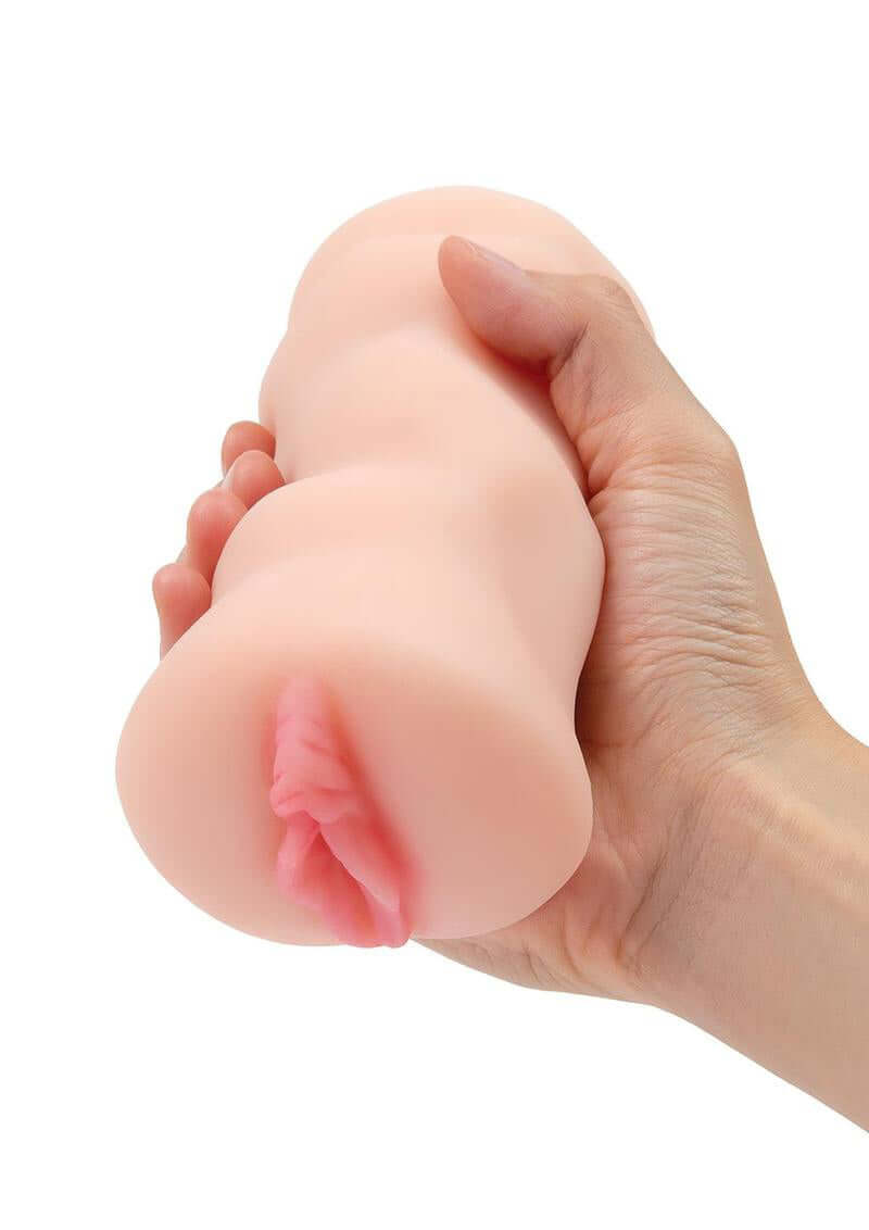 Hand holding ZOLO Porno Pussy Stroker with ultra-realistic texture for enhanced pleasure and sensation.