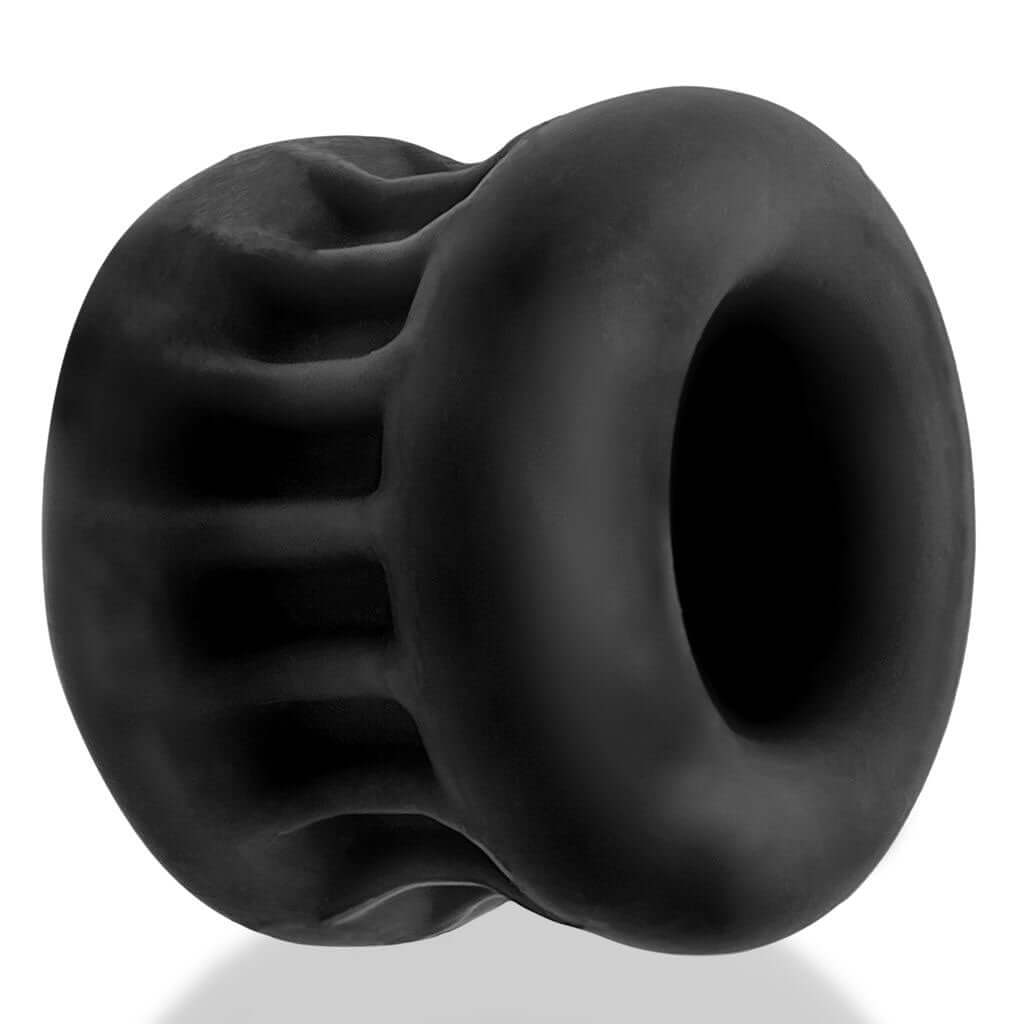 Oxballs Core Gripsqueeze Ballstretcher in Black Ice, featuring outer ribs for enhanced stretch and smooth hourglass inner sleeve for a firm squeeze