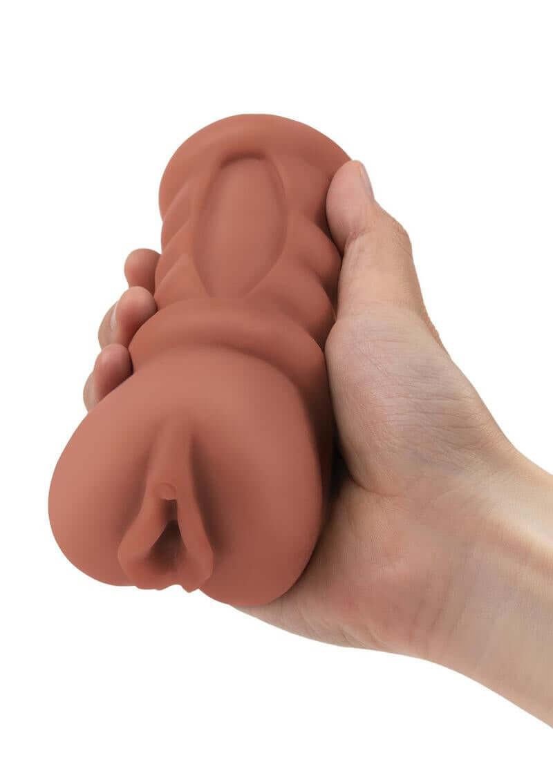 Hand holding Stroke Off Latina Stroker - Medium with lifelike tan texture for ultra realistic sensations.