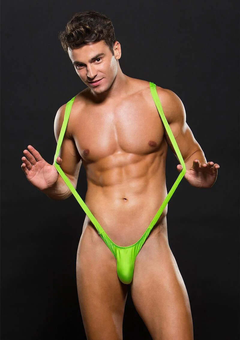 Borat Slingshot Mens Lingerie Medium Large Green displayed by a muscular man in a striking pose.