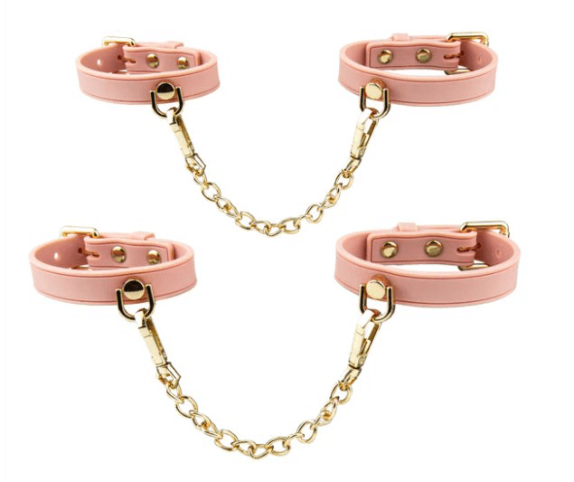 Temptasia Ardor Wrist & Ankle Restraints Pink set featuring pink silicone cuffs with gold hardware and chains.