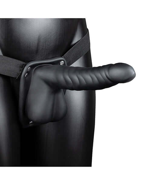Ouch 8 inch Ribbed Hollow Strap On with Balls Black displayed on a mannequin with adjustable harness system.