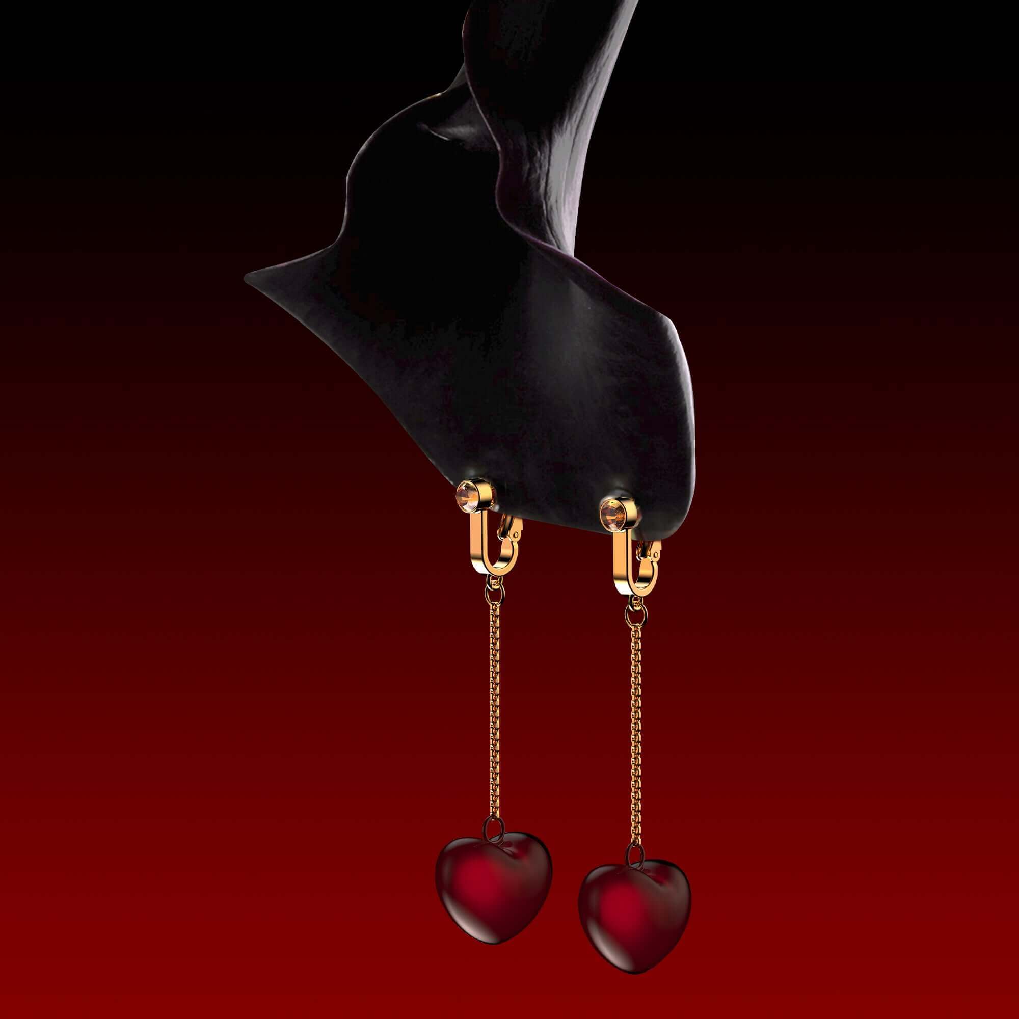 Elegant non-pierced clitoral jewelry with heart-shaped pendants in red, made of zinc alloy and brass with electrolytic gold accents.