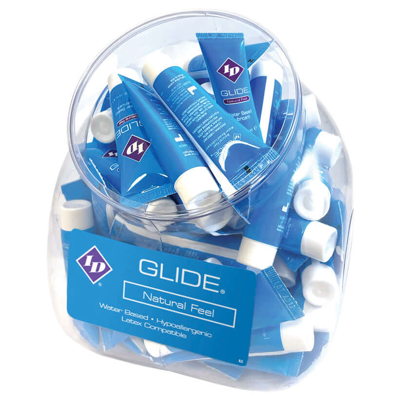 ID Glide Natural Feel Lubricant 12 ml Tubes Bowl Of 72 in a clear container filled with blue tubes.