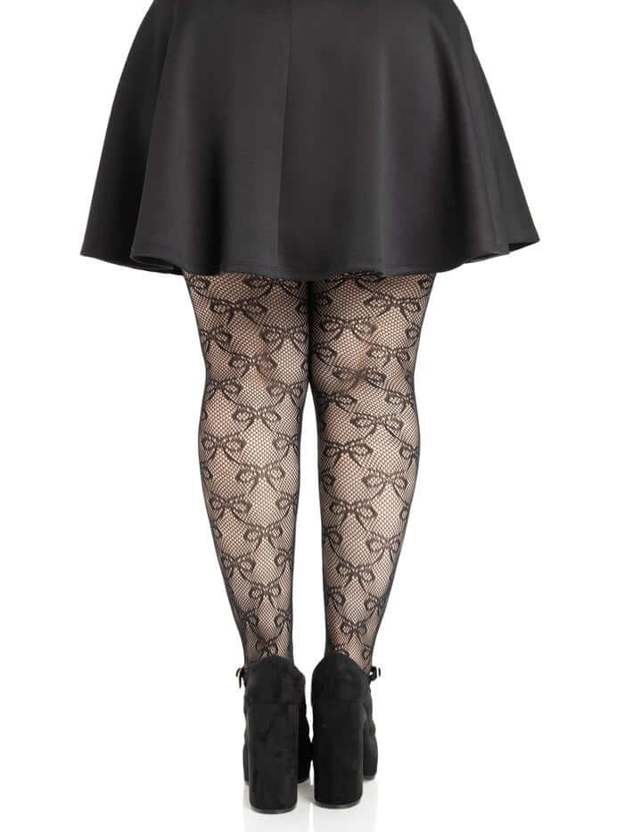 Leg Avenue Plus Size Bow Net Tights 1X 2X Black worn with a short black skirt, showcasing the elegant bow net pattern.