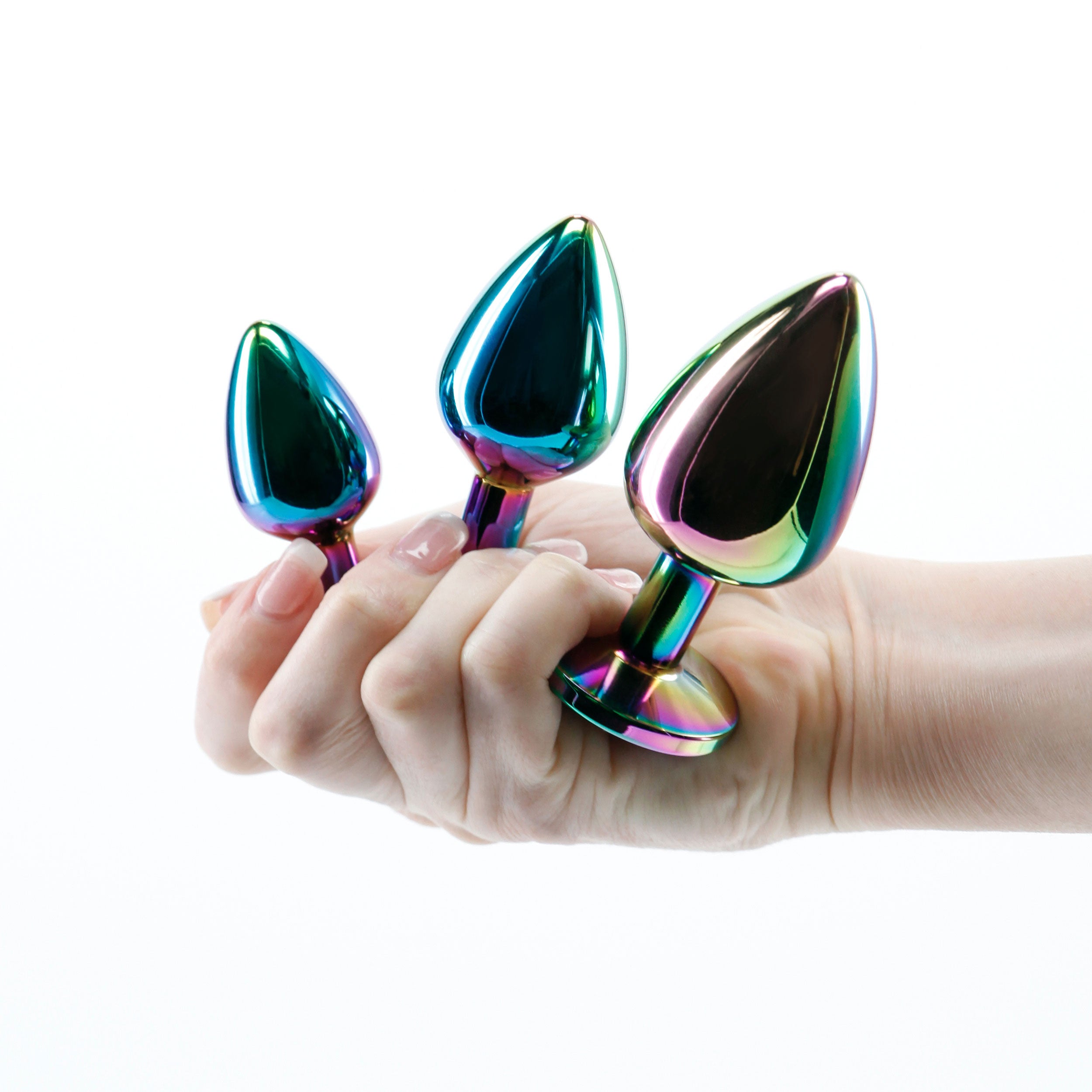 Rear Assets Trainer Kit Multicolor Rainbow featuring three chrome-plated metal plugs in a hand.