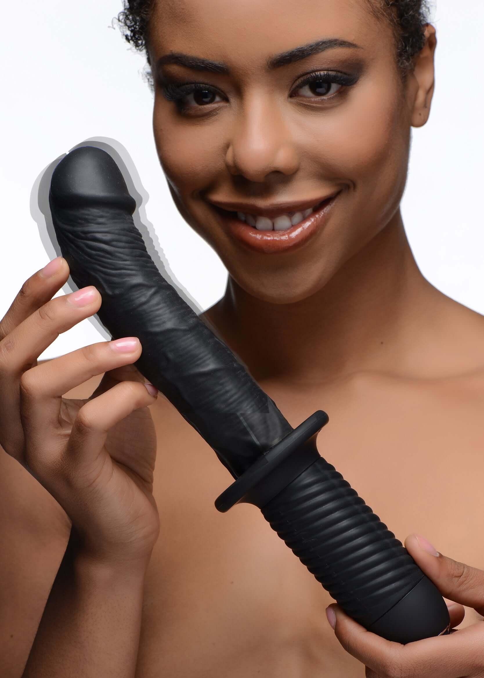 A person smiling while holding The Large Realistic 10X Silicone Vibrator with Handle.