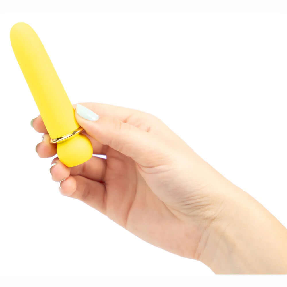 Hand holding yellow Maia Novelties Jaguar, a powerful bullet vibrator with 5 speeds and 5 patterns, 100% silicone coated and fully submersible.
