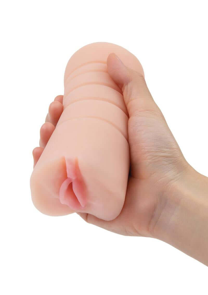 Hand holding ZOLO Vibrating Pussy Stroker with lifelike texture and multi-speed vibrating bullet for intense pleasure.
