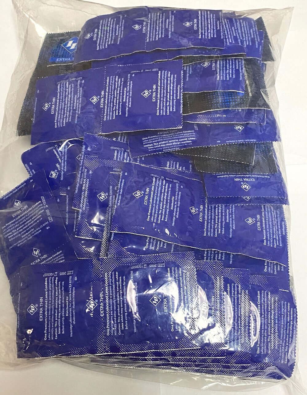 ID Extra Thin Condoms Bag 144 Pieces Bulk, showing sealed condoms for enhanced sensitivity and protection.