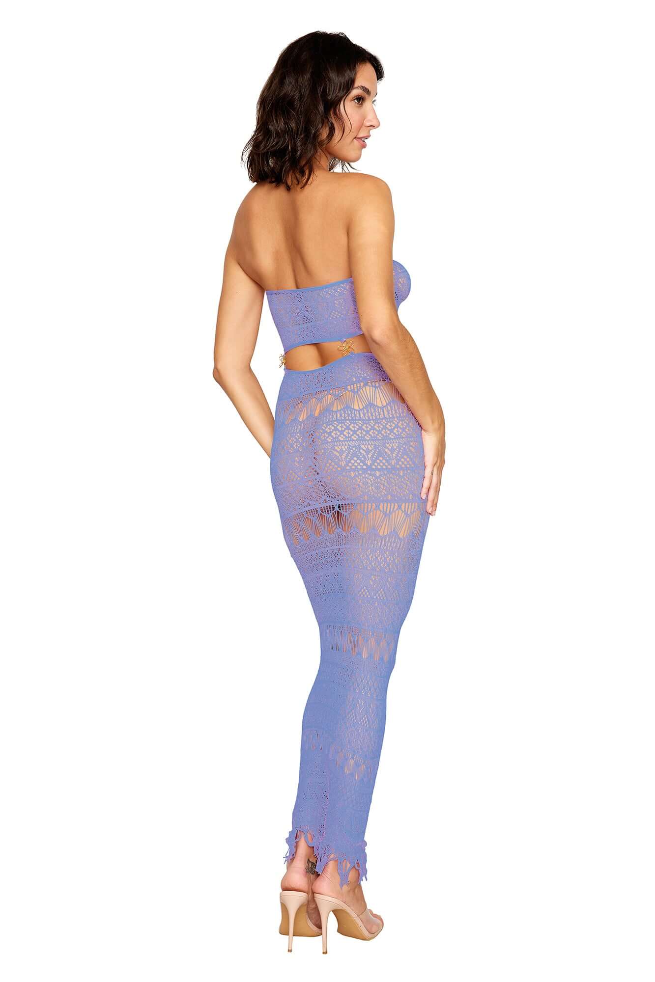 Back view of woman wearing lavender crochet knit bodystocking gown with strapless neckline, cutout bodice detail, and tassel hem.