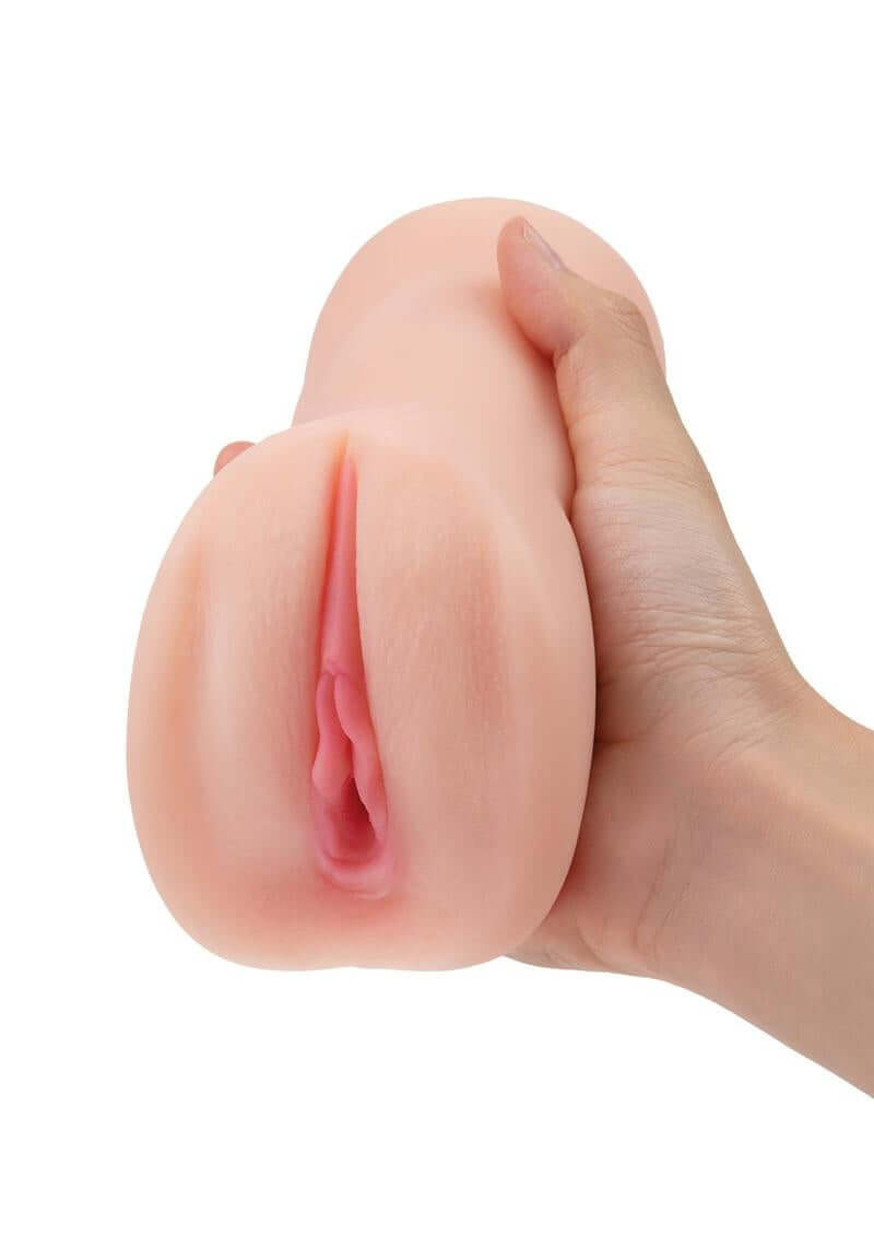 Hand holding ZOLO Pornstar Pussy Stroker with ultra realistic sensations and textured canals for adult pleasure.