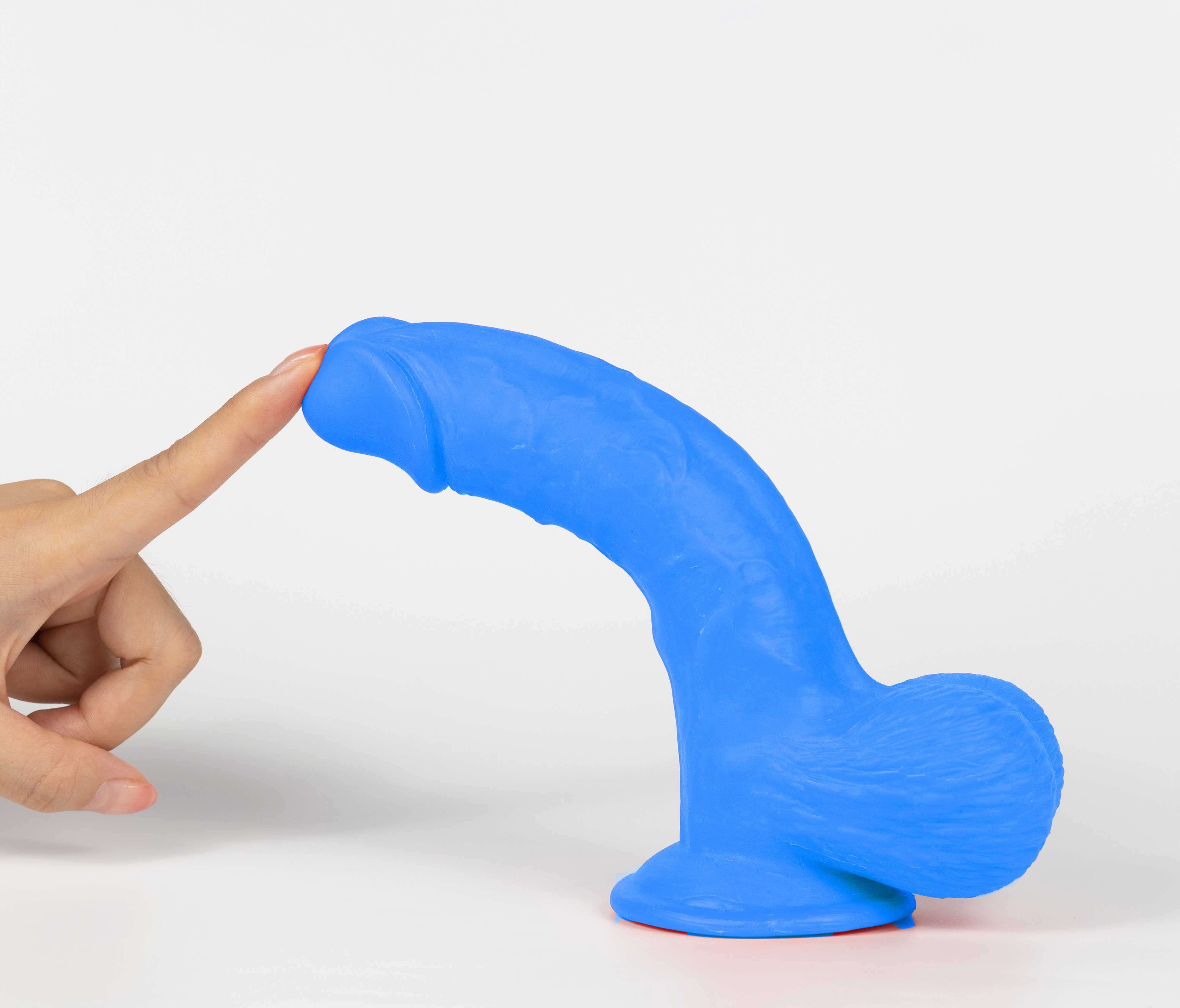 Real Skin Mr Navy 7.5 inches Dual Layer Dildo in blue with finger touching it.