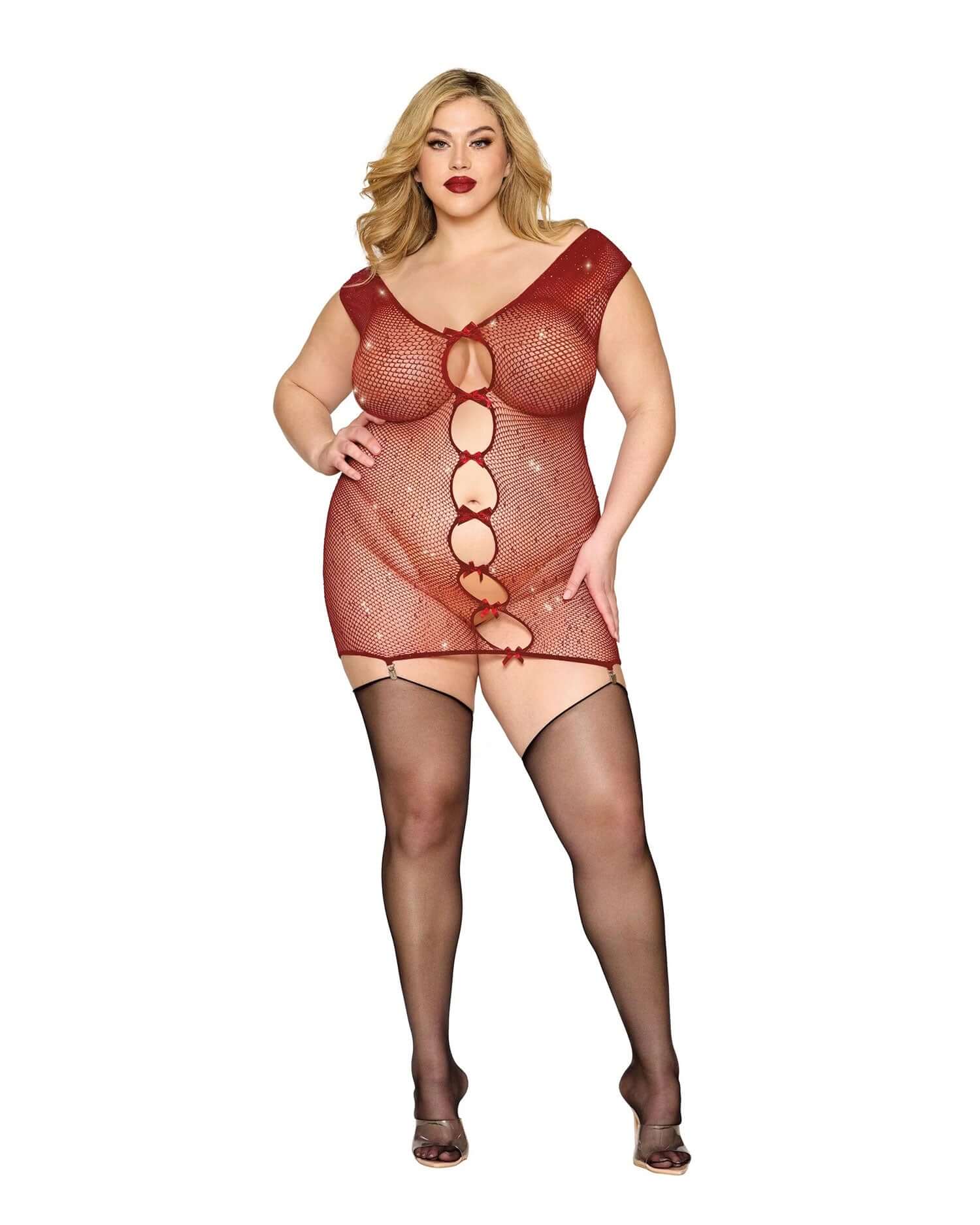 Plus size model wearing red garter slip DMND with fishnet design and black stockings, made of 93% nylon and 7% spandex.