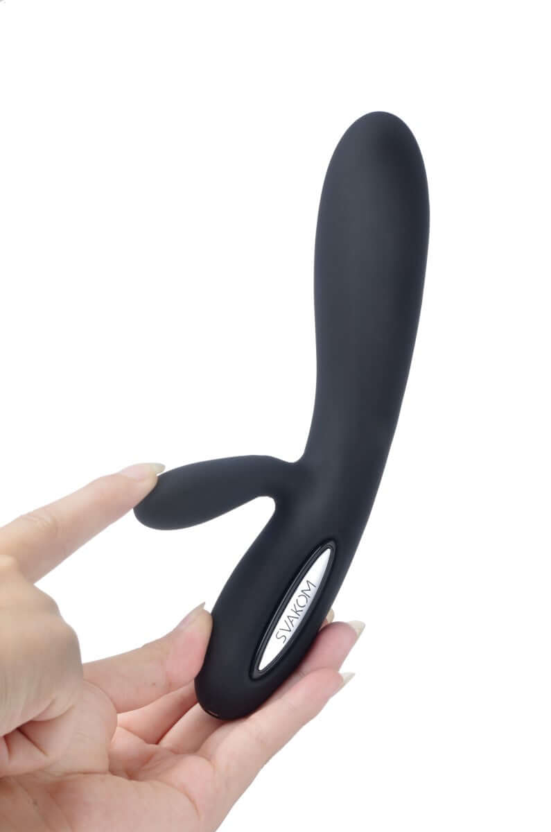 Svakom Lucas Dual-Motor G-Spot & Clitoral Vibrator Black held in a hand, showcasing its sleek design.