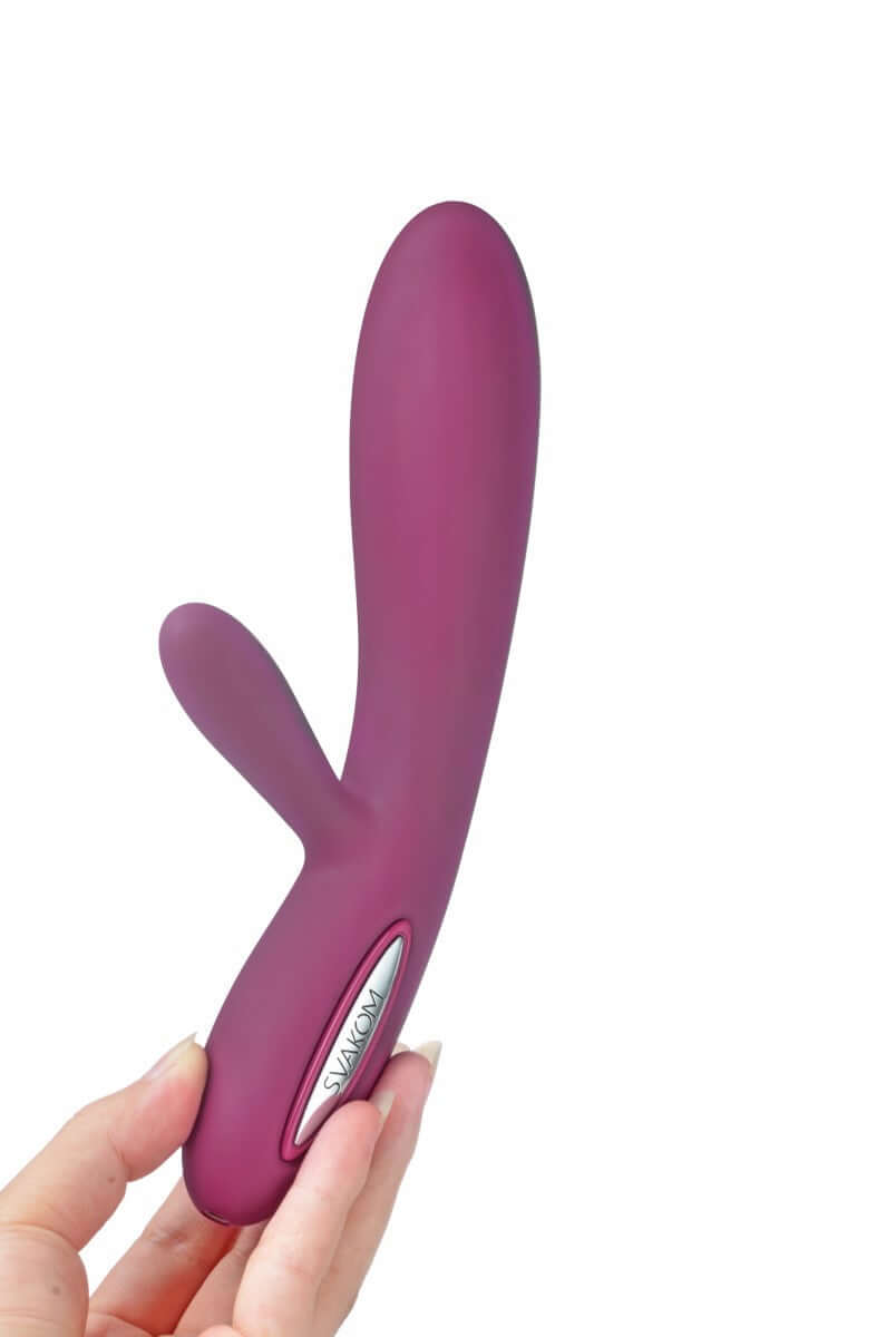 Svakom Lucas Dual-Motor G-Spot & Clitoral Vibrator Violet held in hand, stylish design for pleasure.