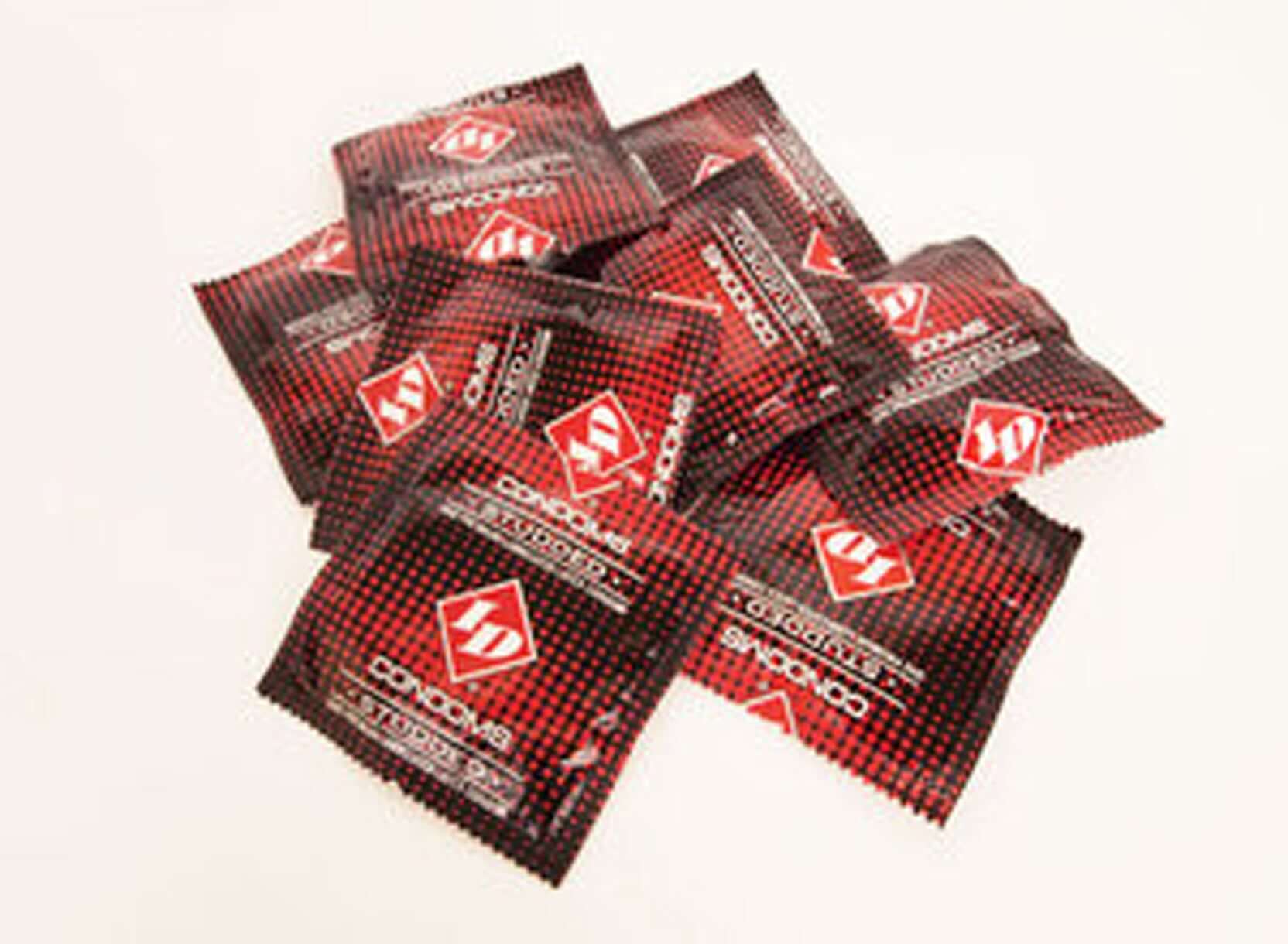 Pile of ID Studded Lubricated Condoms in black and red packaging designed to enhance intimate experiences while ensuring safety