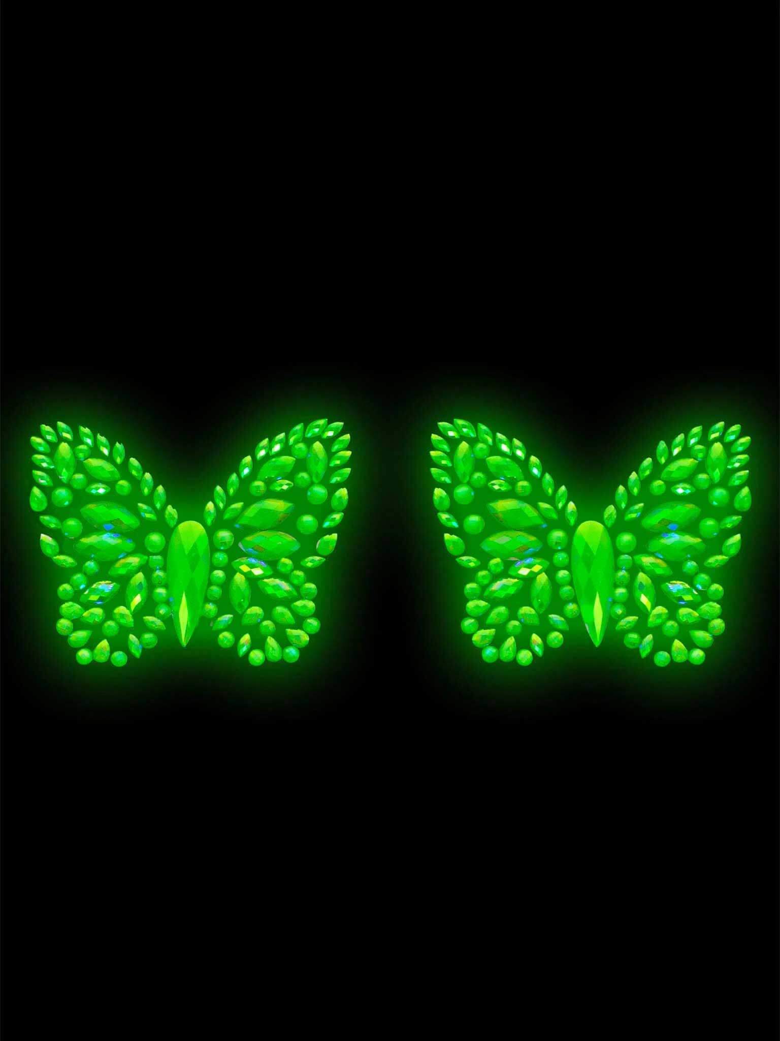 Glow-in-the-dark butterfly nipple pasties with iridescent rhinestones, perfect for festival outfits and skin-friendly application.
