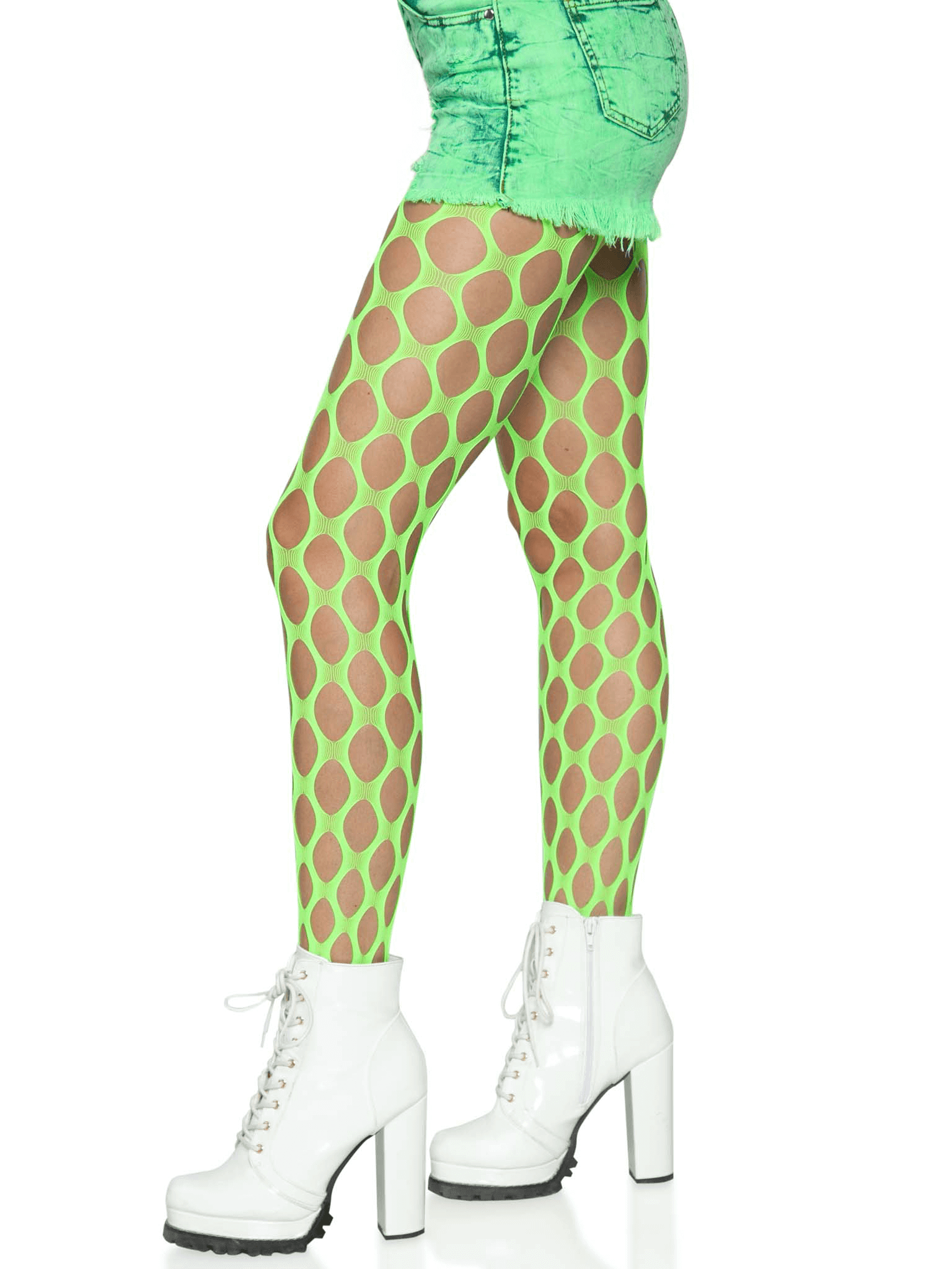 Model wearing Jumbo Pothole Net Tights in Neon Green paired with white boots and a green skirt.