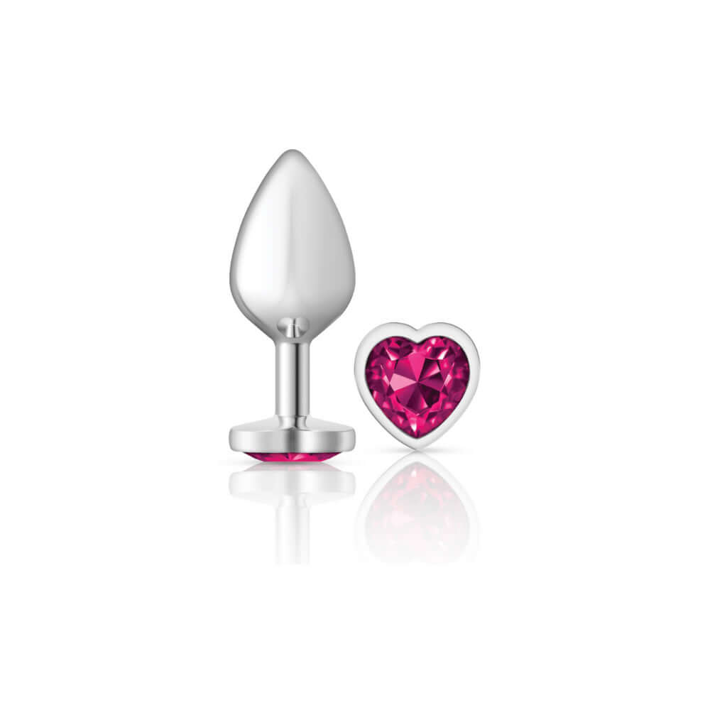 Silver metal butt plug with bright pink heart-shaped gemstone from Cheeky Charms collection.
