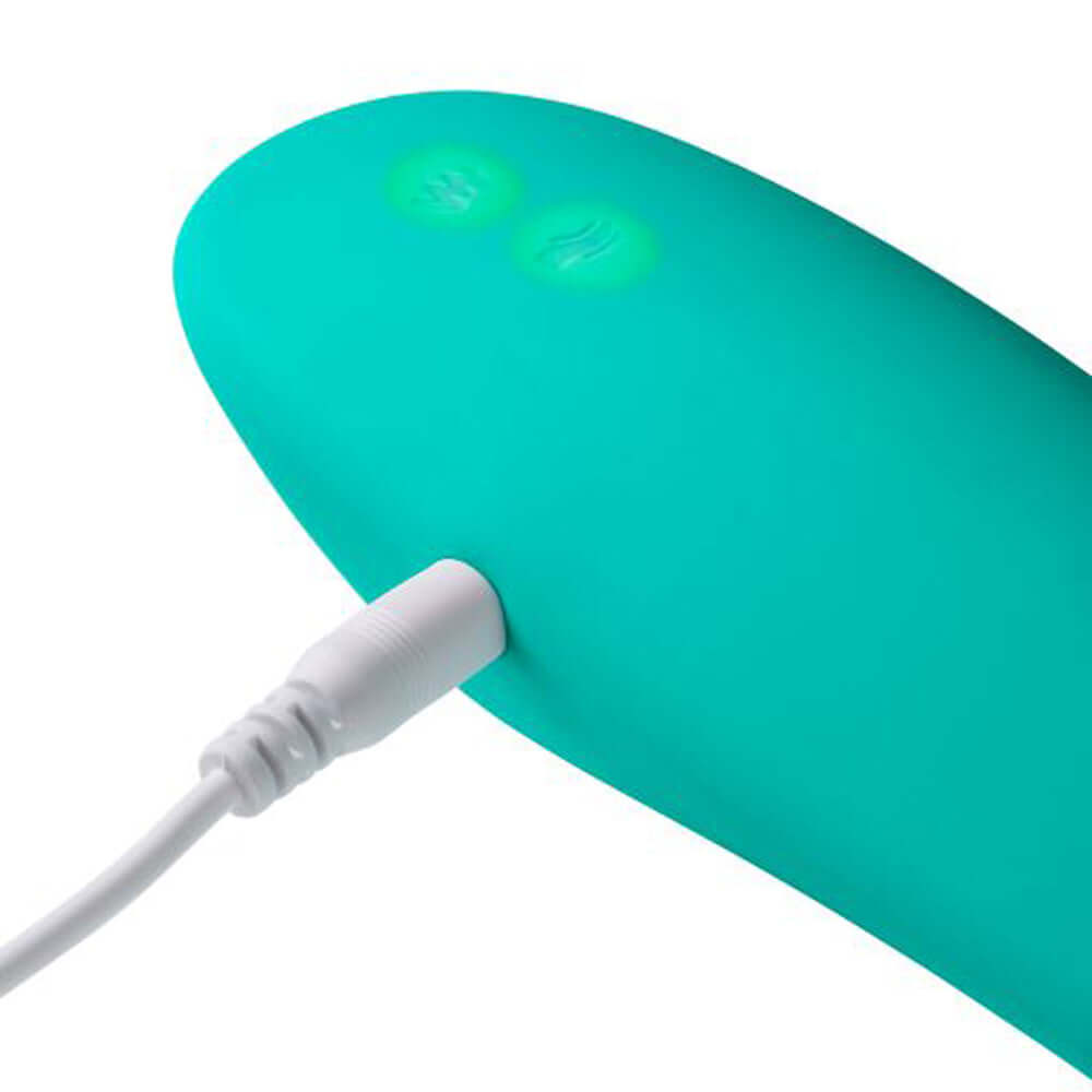 Teal Health and Wellness Oral Flutter Plus charging with a close-up of the power connector.