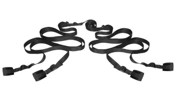 Black H-shaped bed restraint straps designed for secure cuffing of ankles and wrists, ideal for enhancing intimate experiences.