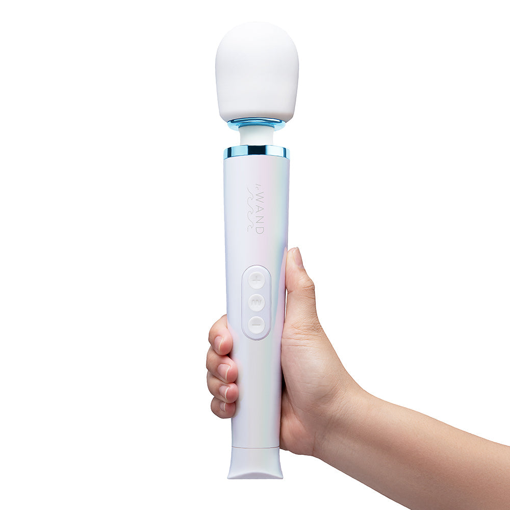 Le Wand Dive Submersible Vibrating Massager Seashell held in hand, showcasing its sleek design and controls.