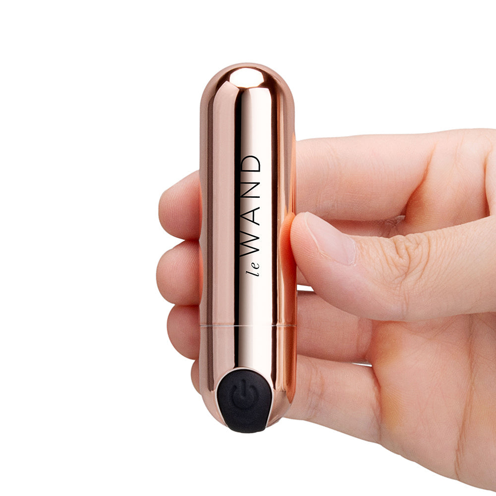 Le Wand Essentials Mini Rose Gold Bullet Vibrator held in hand showcasing its elegant design.